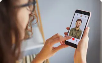 A woman scrolling a dating app on her phone